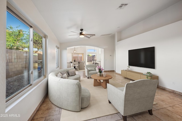6309 W Hughes Dr, Phoenix, AZ 85043 - living area with arched walkways, lofted ceiling, a ceiling fan, tile patterned floors, and baseboards