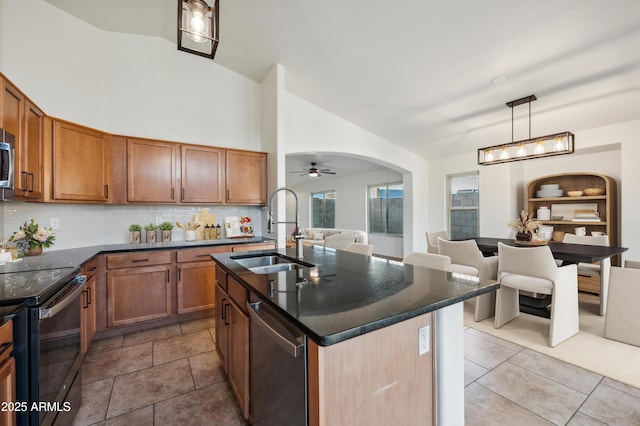 6309 W Hughes Dr, Phoenix, AZ 85043 - kitchen with a sink, appliances with stainless steel finishes, open floor plan, tasteful backsplash, and brown cabinetry
