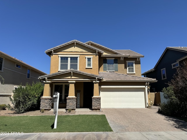 craftsman inspired home with a garage and a porch