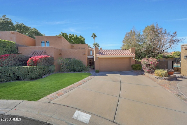 view of front of property featuring a garage and a front yard