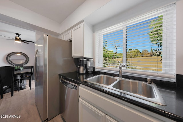 kitchen with sink, stainless steel dishwasher, ceiling fan, light hardwood / wood-style floors, and white cabinets