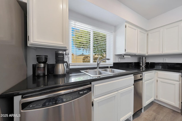 kitchen featuring sink, light hardwood / wood-style floors, white cabinets, and dishwasher