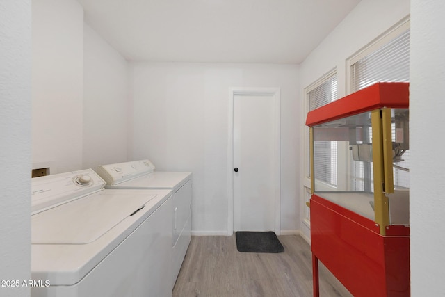 washroom featuring separate washer and dryer and light hardwood / wood-style flooring