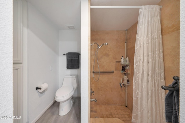 bathroom featuring toilet and a shower with shower curtain