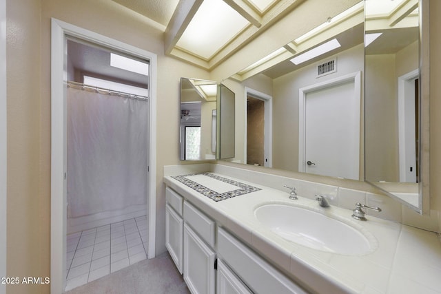 bathroom featuring vanity, a shower with curtain, and tile patterned floors