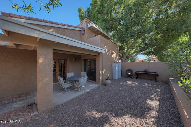 rear view of house with a patio and french doors