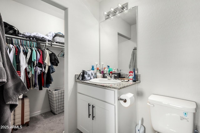 bathroom with toilet and vanity