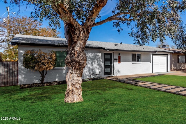 ranch-style house with an attached garage, brick siding, fence, and a front yard