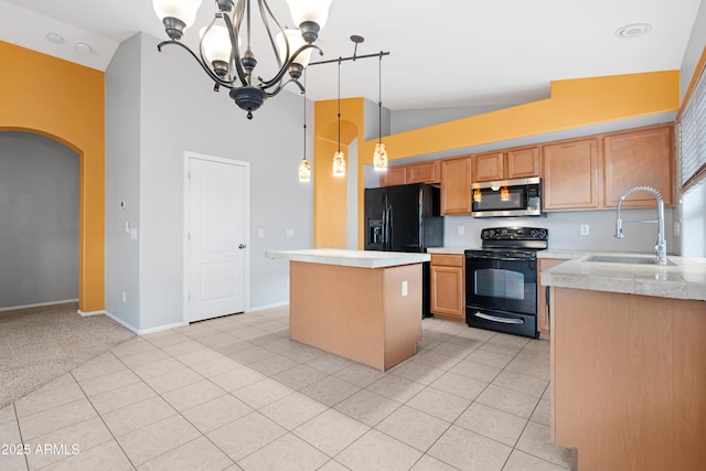 kitchen featuring black appliances, light tile patterned floors, arched walkways, and a sink