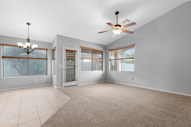 unfurnished room featuring baseboards, lofted ceiling, light tile patterned flooring, ceiling fan with notable chandelier, and light colored carpet