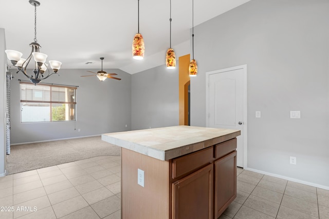 kitchen with light tile patterned floors, lofted ceiling, decorative light fixtures, ceiling fan with notable chandelier, and light colored carpet