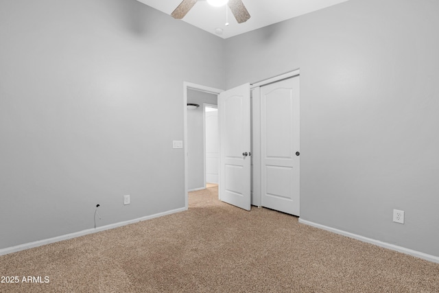 unfurnished bedroom with a ceiling fan, carpet, baseboards, and a closet