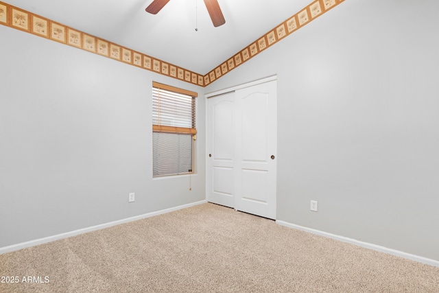 spare room with a ceiling fan, baseboards, and carpet floors