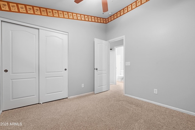 unfurnished bedroom featuring a closet, carpet floors, baseboards, and a ceiling fan