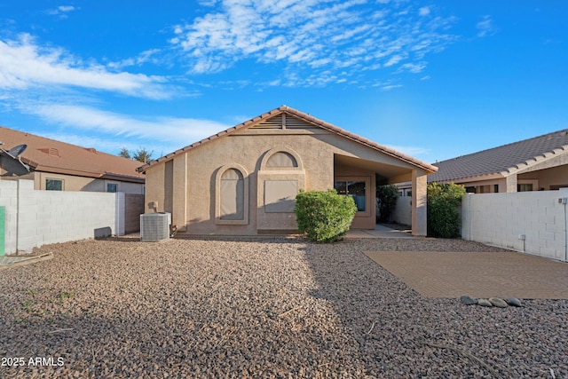 back of house with a patio, a fenced backyard, central AC, and stucco siding