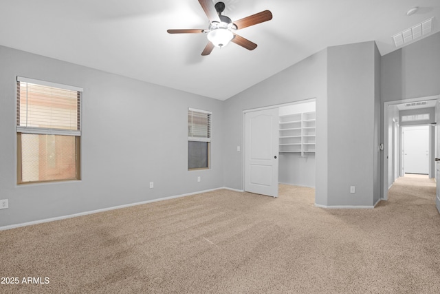 unfurnished bedroom featuring vaulted ceiling, carpet flooring, baseboards, and visible vents