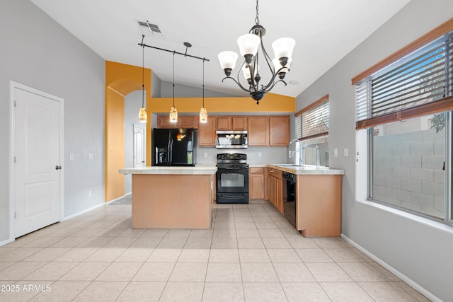 kitchen with visible vents, arched walkways, a sink, black appliances, and a center island