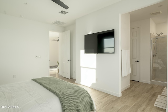 bedroom with ceiling fan, light wood-type flooring, connected bathroom, and a closet