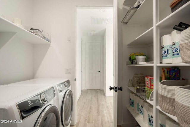 laundry room featuring independent washer and dryer and light wood-type flooring