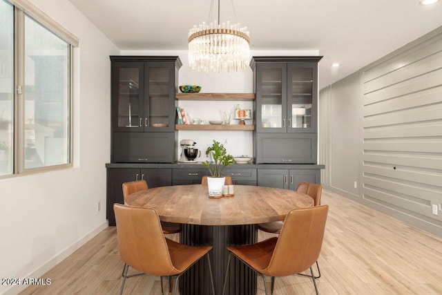 dining area featuring a chandelier and light wood-type flooring