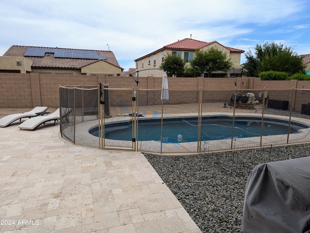 view of swimming pool featuring area for grilling and a patio area