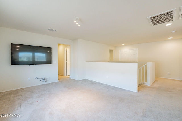 unfurnished living room with light carpet