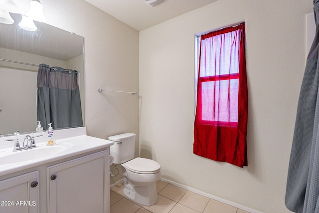 bathroom featuring vanity, tile patterned flooring, toilet, and curtained shower