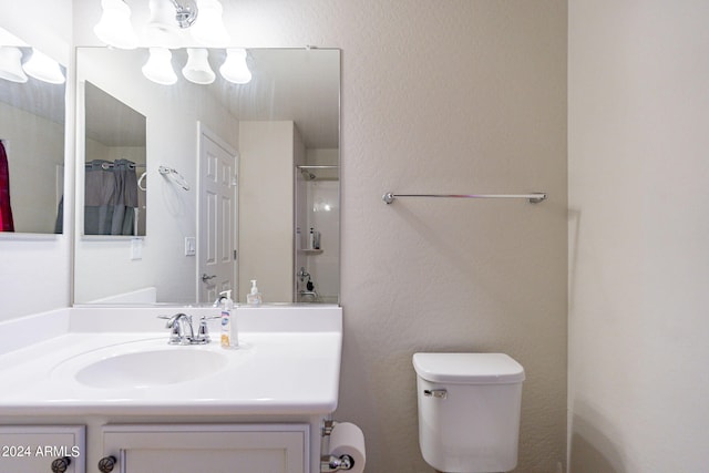 bathroom with vanity, toilet, and curtained shower