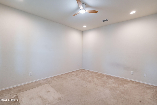 spare room with light carpet and ceiling fan