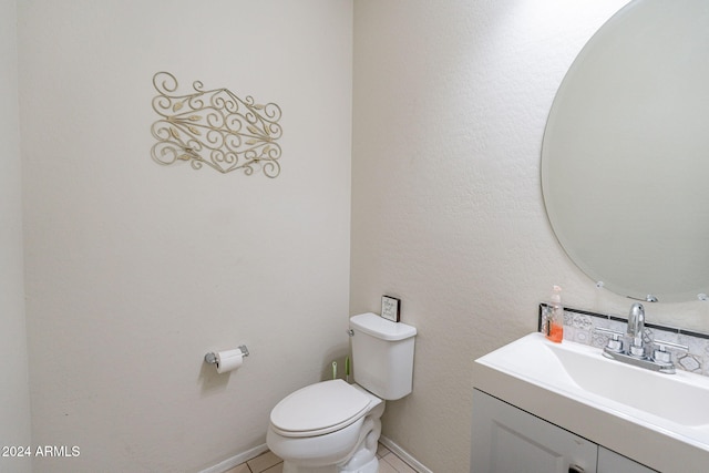 bathroom with tile patterned floors, vanity, and toilet