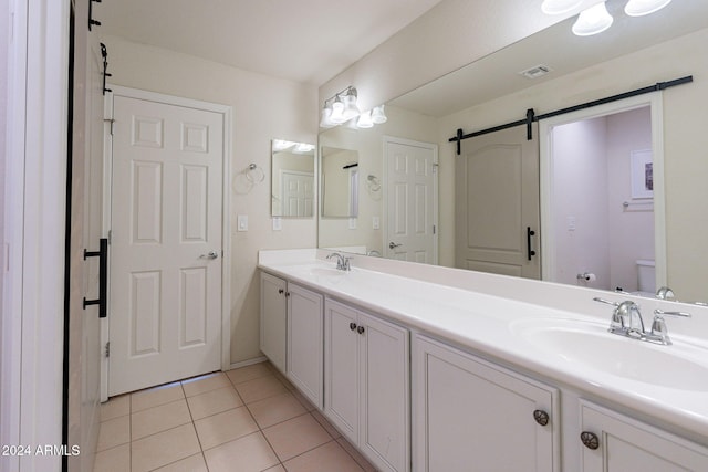 bathroom with tile patterned floors, vanity, and toilet