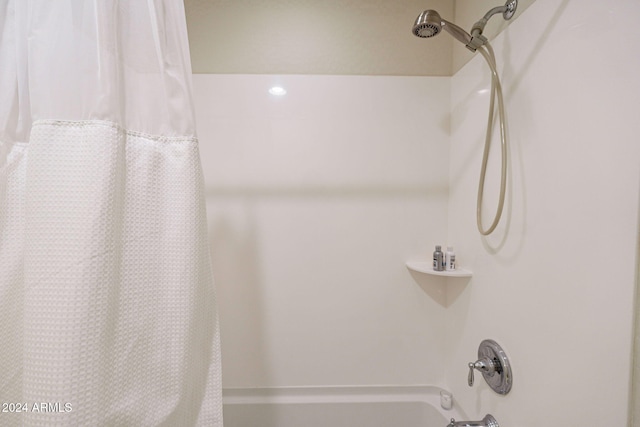 bathroom featuring shower / tub combo with curtain