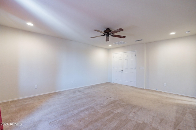 unfurnished room featuring light carpet and ceiling fan