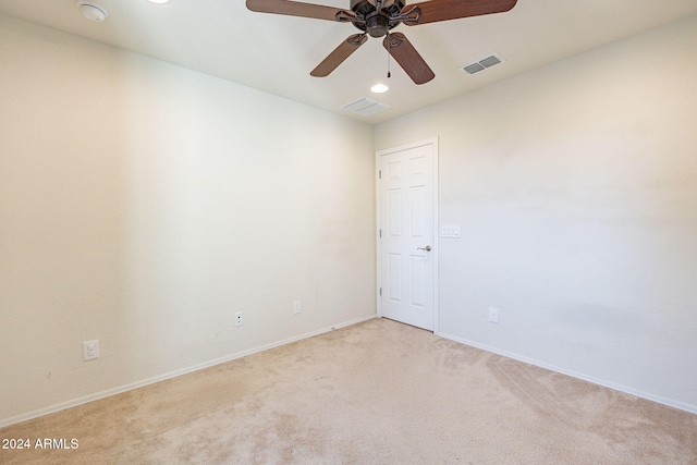 unfurnished room with ceiling fan and light carpet