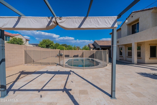 view of swimming pool with a jacuzzi and a patio