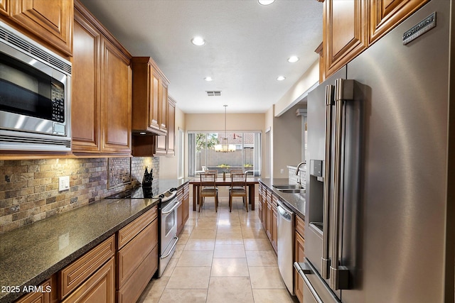 3350 E Rosemonte Dr, Phoenix, AZ 85050 - kitchen with appliances with stainless steel finishes, recessed lighting, a sink, decorative backsplash, and brown cabinets