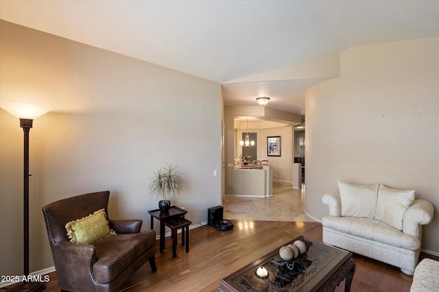 3350 E Rosemonte Dr, Phoenix, AZ 85050 - living area featuring wood finished floors, lofted ceiling, and baseboards