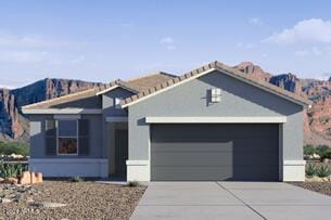 view of front of house with a garage and a mountain view