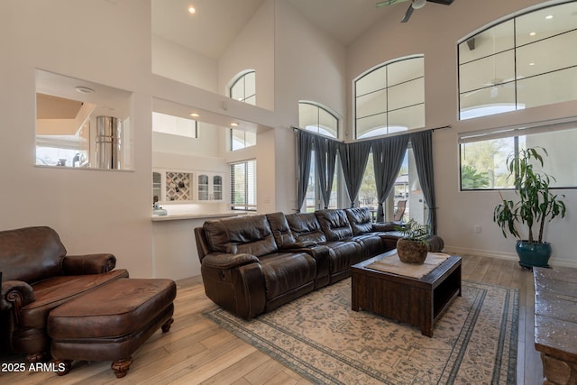 8502 E Santa Catalina Dr, Scottsdale, AZ 85255 - living room featuring light wood finished floors, a high ceiling, and baseboards