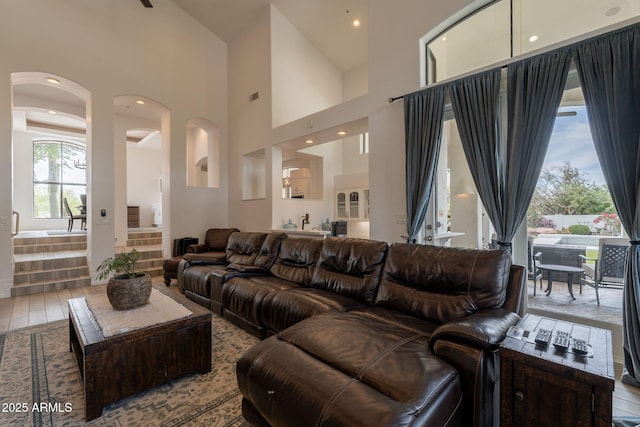 8502 E Santa Catalina Dr, Scottsdale, AZ 85255 - living room featuring arched walkways, wood finished floors, a high ceiling, and recessed lighting