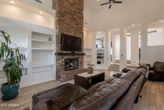 8502 E Santa Catalina Dr, Scottsdale, AZ 85255 - living room with built in features, a towering ceiling, wood finished floors, and recessed lighting