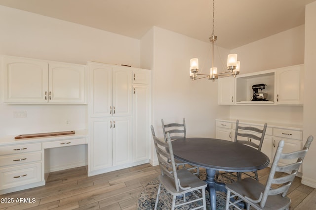 8502 E Santa Catalina Dr, Scottsdale, AZ 85255 - dining space featuring light wood-style flooring, a chandelier, and baseboards