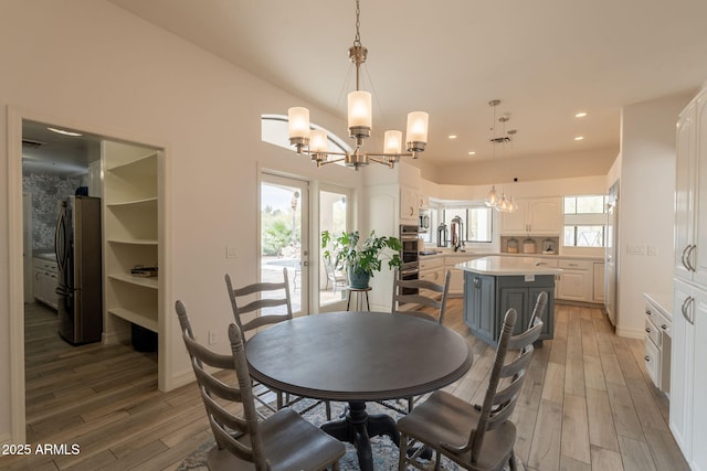8502 E Santa Catalina Dr, Scottsdale, AZ 85255 - dining room with a chandelier, light wood-type flooring, recessed lighting, and baseboards