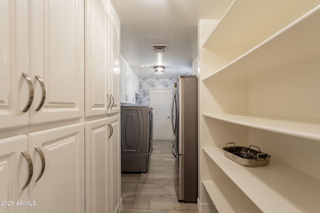 8502 E Santa Catalina Dr, Scottsdale, AZ 85255 - laundry area with light wood-type flooring and washing machine and dryer