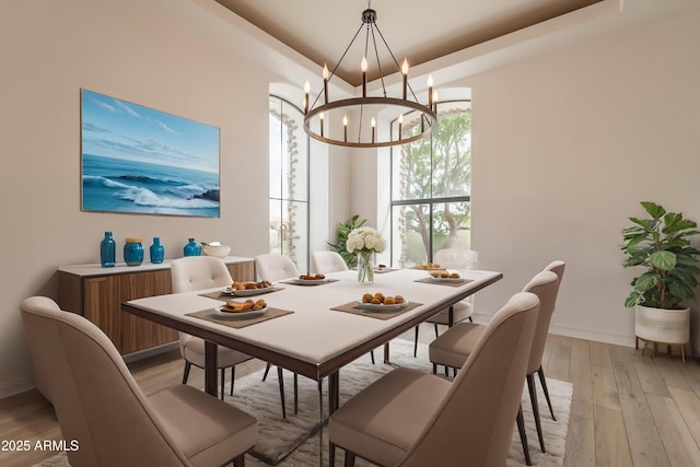 8502 E Santa Catalina Dr, Scottsdale, AZ 85255 - dining area with light wood-style flooring, a chandelier, baseboards, and a tray ceiling