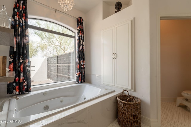 8502 E Santa Catalina Dr, Scottsdale, AZ 85255 - bathroom featuring a tub with jets, toilet, and baseboards