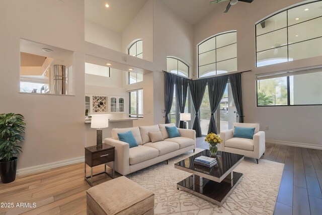 8502 E Santa Catalina Dr, Scottsdale, AZ 85255 - living area featuring baseboards, wood-type flooring, a high ceiling, and recessed lighting