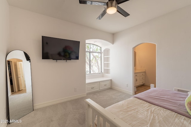 8502 E Santa Catalina Dr, Scottsdale, AZ 85255 - bedroom featuring arched walkways, light colored carpet, baseboards, and ensuite bathroom