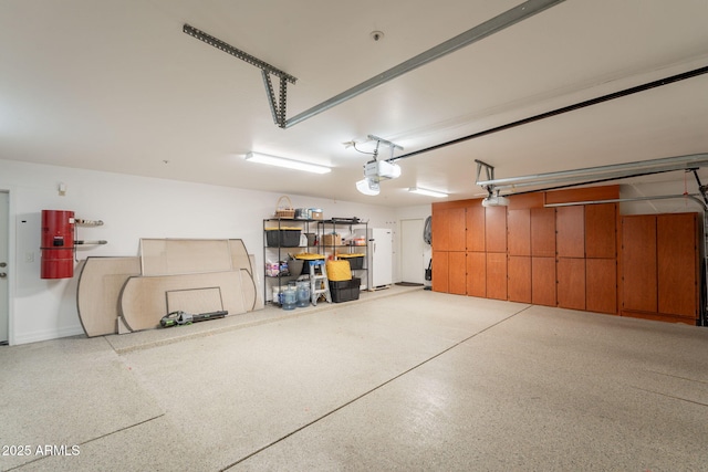 8502 E Santa Catalina Dr, Scottsdale, AZ 85255 - garage featuring a garage door opener, freestanding refrigerator, and a central vacuum unit