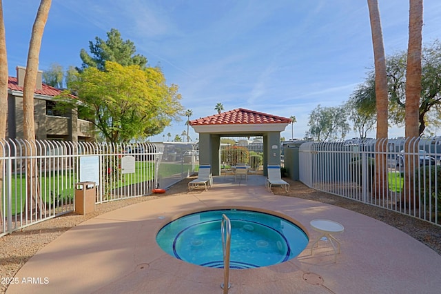 view of swimming pool featuring a hot tub, a gazebo, and a patio area